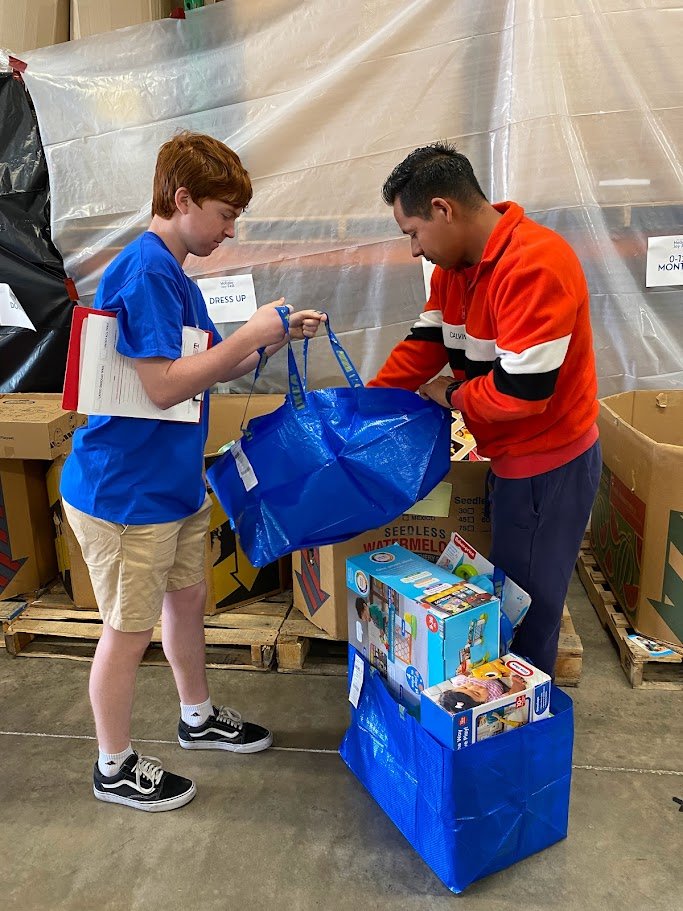volunteer handing out gifts